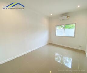 Empty room with tiled floor, air conditioning, and a window