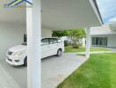 Covered carport with a white car parked next to a modern house