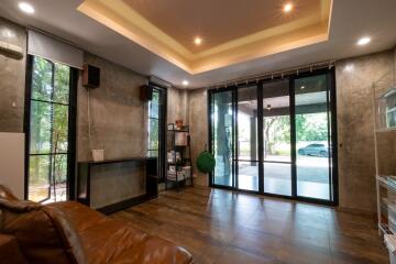 spacious living room with large windows and modern lighting