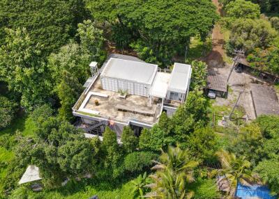 Aerial view of modern building surrounded by lush greenery