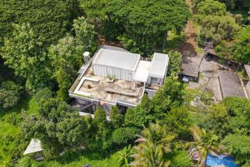 Aerial view of modern building surrounded by lush greenery