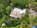 Aerial view of modern building surrounded by lush greenery