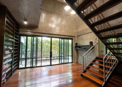 Modern main living space with large windows and staircase