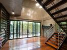 Modern main living space with large windows and staircase