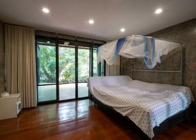 Bedroom with large windows and a canopy bed