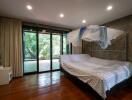 Bedroom with large windows and a canopy bed