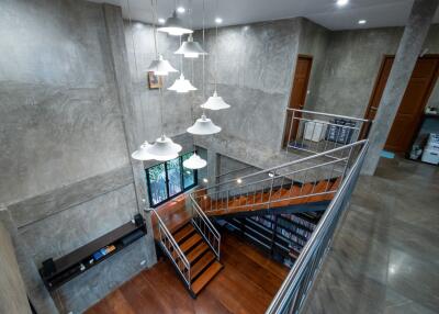 Modern industrial-style hallway with staircase