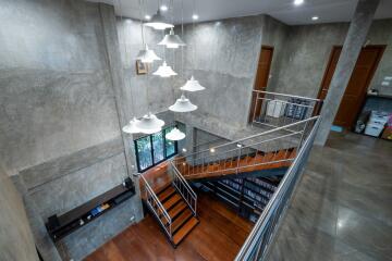 Modern industrial-style hallway with staircase