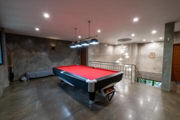 Spacious game room with a pool table