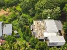 Aerial view of a house surrounded by greenery