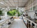 Outdoor kitchen with white tiled counters and open shelving