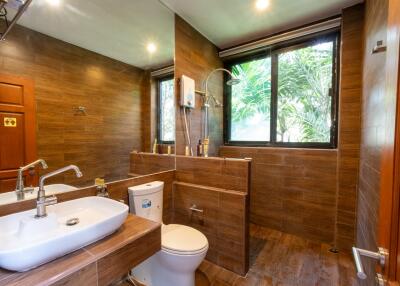 Modern bathroom with large mirror and window