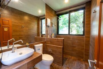 Modern bathroom with large mirror and window