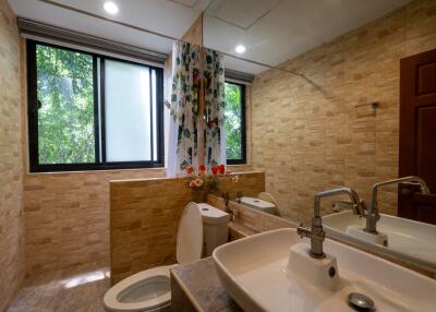 Modern bathroom with double sinks and large windows