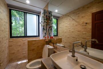 Modern bathroom with double sinks and large windows