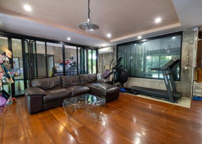 Spacious living room with gym equipment and modern decor