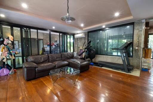 Spacious living room with gym equipment and modern decor