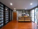 Spacious walk-in closet with wooden floors and built-in shelves