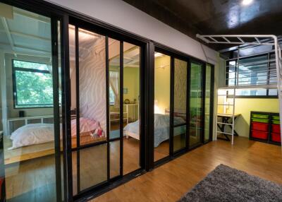 Modern bedroom with loft bed and large windows