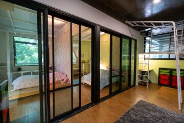 Modern bedroom with loft bed and large windows