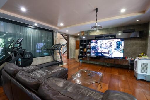 Modern living room with gym equipment and large TV