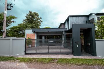 Modern house exterior with gated driveway