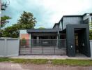 Modern house exterior with gated driveway