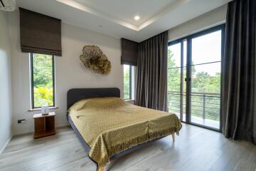 Modern bedroom with large windows and scenic view