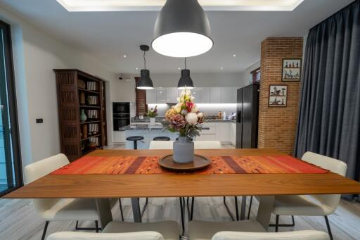 Modern dining area with wooden table and contemporary lighting