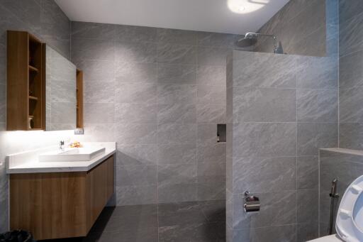 Modern bathroom with marble tiles and a walk-in shower