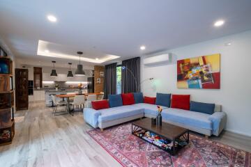 Modern living room with an open kitchen and dining area