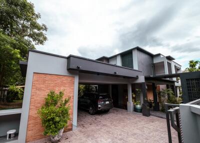 Modern residential house exterior with driveway and carport