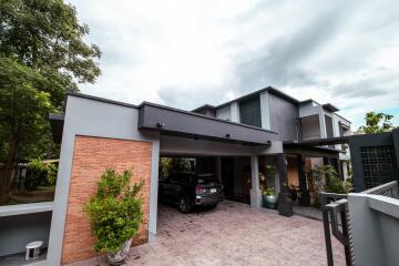 Modern residential house exterior with driveway and carport