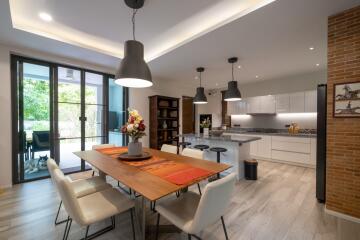 Modern kitchen with dining table and pendant lights