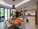 Modern kitchen with dining table and pendant lights