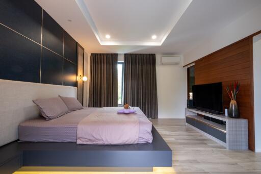 Modern bedroom with platform bed and entertainment unit