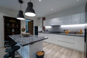 Modern kitchen with granite countertops and white cabinetry