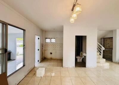 Main living area with large windows, tiled floor, modern lighting, and connected bathroom