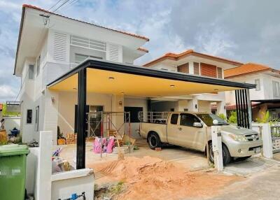 Front view of a modern house with a driveway and car parked