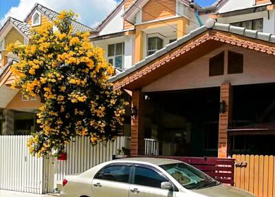 Front view of a house with a driveway and parked car