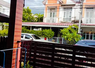 Covered area overlooking street with view of neighboring houses