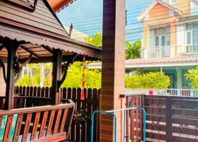 Front porch with wooden bench and plants