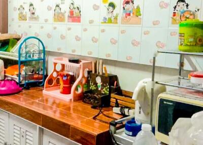 Colorful kitchen with various appliances and decorated tiles