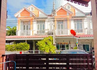 View of two-story houses from a gated entry