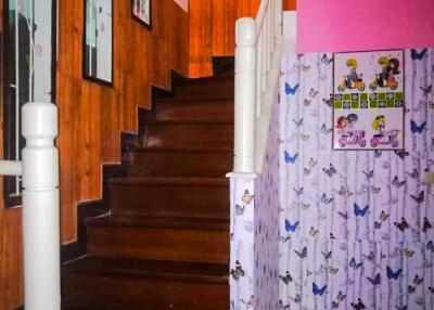 View of a wooden staircase with wall decorations