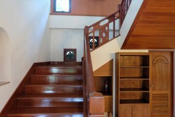 Wooden staircase with built-in shelving