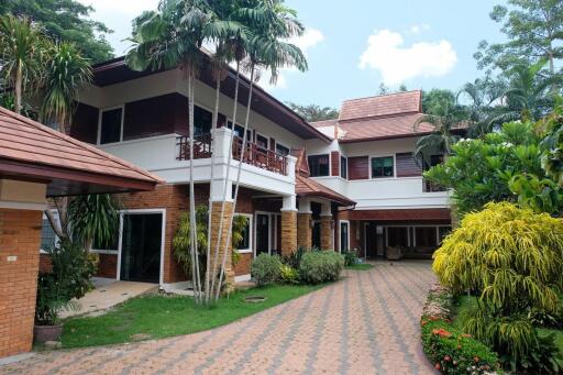 Outdoor view of a large two-story house with well-maintained garden