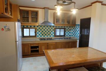 Welcoming kitchen space with wooden cabinetry and modern appliances