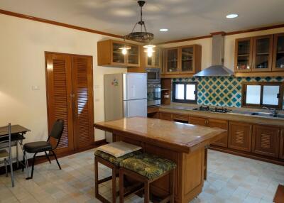 Spacious kitchen with island, modern appliances, and dining area