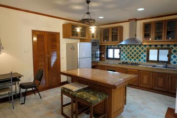 Spacious kitchen with island, modern appliances, and dining area